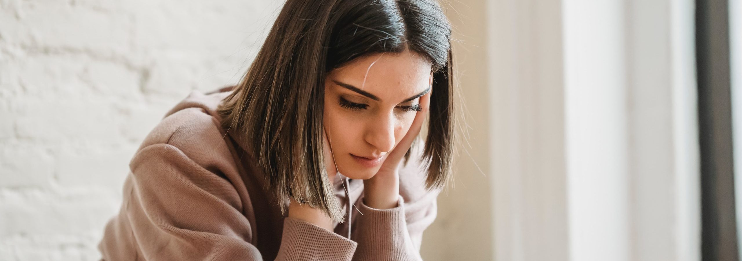 Thinking woman with cash concerns